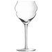 A clear wine glass with a curved stem.