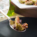 A close-up of a Walco stainless steel serving spoon with food on it.