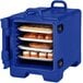 A navy blue Cambro front loading food pan carrier with trays of pastries inside.