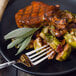 A plate of food with a Walco Art Deco stainless steel dinner fork.