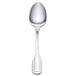 A Walco Luxor stainless steel demitasse spoon with a silver handle.