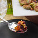 A Walco stainless steel serving spoon with food on it.
