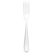 A close-up of a Walco stainless steel dinner fork with a white handle.