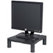 A black Kelly adjustable monitor stand with a computer monitor on it.