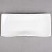 A white rectangular Villeroy & Boch porcelain plate with a curved edge.