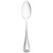 A Walco stainless steel dessert spoon with a silver handle on a white background.