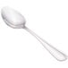 A close-up of a Walco stainless steel dessert spoon with a silver handle.