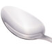 A close-up of a Walco stainless steel dessert spoon with a silver handle.