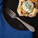 A plate with a pastry and a Walco Danish Pride dinner fork on it.