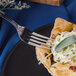 A Walco Danish Pride stainless steel dinner fork spearing a pastry on a white plate.