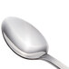 A close-up of a Walco stainless steel dessert spoon with a silver handle.