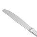 A close-up of a Walco stainless steel dinner knife with a white handle.