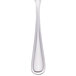 A Walco stainless steel teaspoon with a white handle and silver spoon.