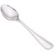 A close-up of a Walco stainless steel teaspoon with a silver handle.