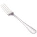 A close-up of a Walco stainless steel table fork with a silver handle.