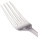 A close-up of a Walco stainless steel table fork with four forks on it.