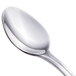 A close-up of a Walco stainless steel demitasse spoon with a silver handle.