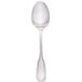 A Walco stainless steel tablespoon with a silver handle.