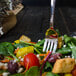 A Walco Meteor stainless steel salad fork in a salad.