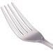 A close-up of four Walco stainless steel utility/salad forks.