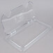 A Carlisle clear polycarbonate container lid with two notches.