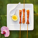 Grilled shrimp skewers on a Villeroy & Boch white bone porcelain square plate.