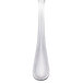 A stainless steel cocktail fork with a white handle.