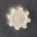 A white gear wheel with a black text on a black surface.