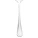 A close-up of a Walco stainless steel serving spoon.
