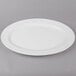 A white Thunder Group oval melamine platter with a white rim on a gray surface.