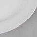 A white Thunder Group oval mid rim melamine platter on a gray surface.