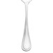 A close-up of a Walco stainless steel dessert spoon.