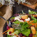 A Walco Barony stainless steel salad fork in a plate of salad.