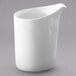 A white Villeroy & Boch porcelain creamer with a handle on a gray surface.