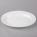 A white Thunder Group oval melamine platter with a rim.