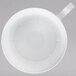 A white plastic WNA Comet coffee cup with a silver rim and handle.