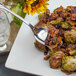 A Walco Barony serving spoon in a plate of food.
