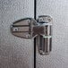 A stainless steel latch on a Norlake Kold Locker metal door.