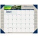 A House of Doolittle desk pad calendar with a picture of a mountain and trees on it.