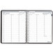 A spiral-bound black and white House of Doolittle planner with a calendar on it.