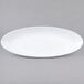 A white oval melamine platter with a rim.