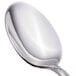 A close-up of a Walco stainless steel serving spoon with a silver handle.