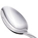 A close-up of a Walco stainless steel teaspoon with a silver handle.