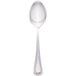 A Walco stainless steel teaspoon with a white handle and silver spoon.