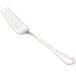 A close-up of a Walco Prim European table fork with a white handle.
