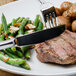 A plate of food with a knife and fork.