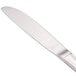 A close-up of a Walco stainless steel butter knife with a solid silver handle.