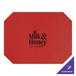 A red leather place mat with black text that says "milk and honey"