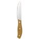 A Libbey steak knife with a bamboo handle.