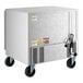 A stainless steel undercounter refrigerator on wheels with a power cord and ventilation grates.